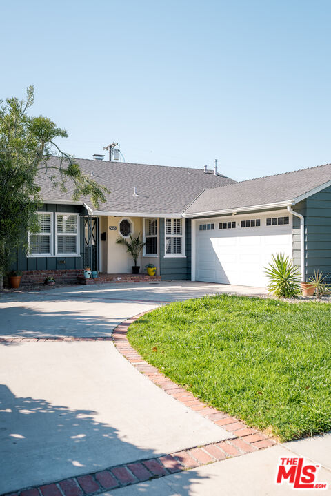 5849 Goodland Avenue Valley Village, CA 91607 - Photo 2 of 25 a front view of a house with a yard