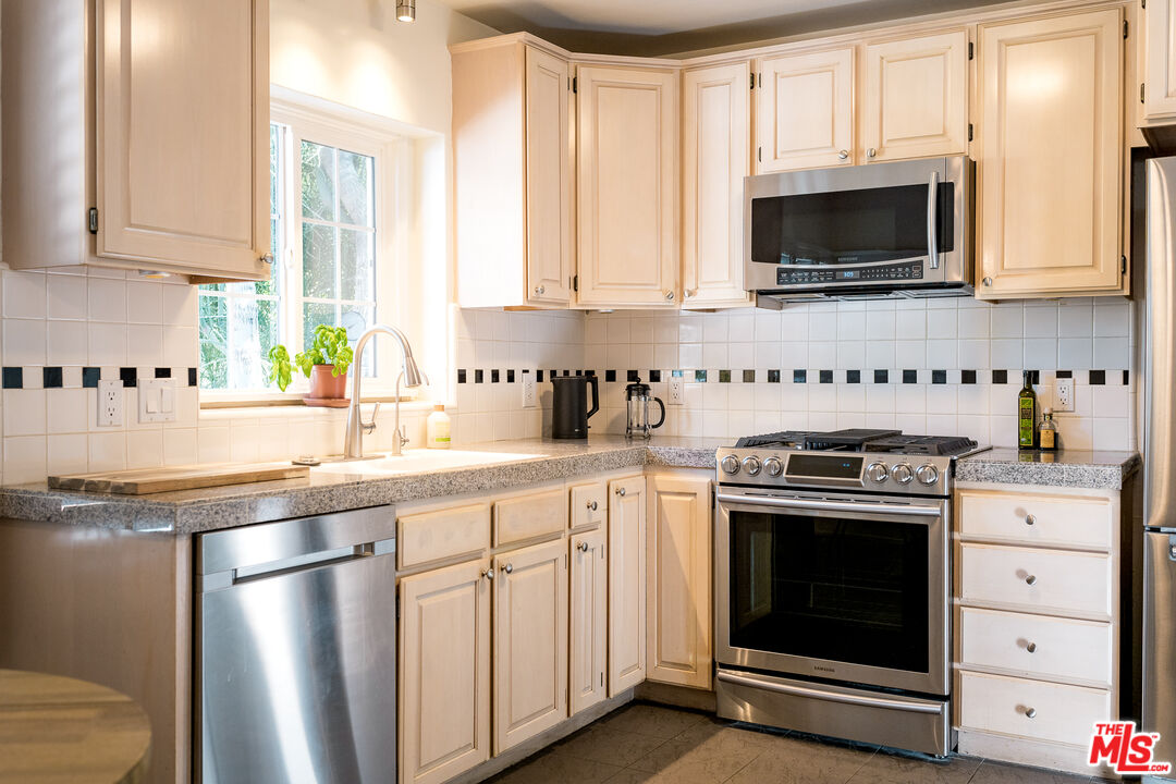 5849 Goodland Avenue Valley Village, CA 91607 - Photo 7 of 25 a kitchen with stainless steel appliances a stove a sink and a microwave