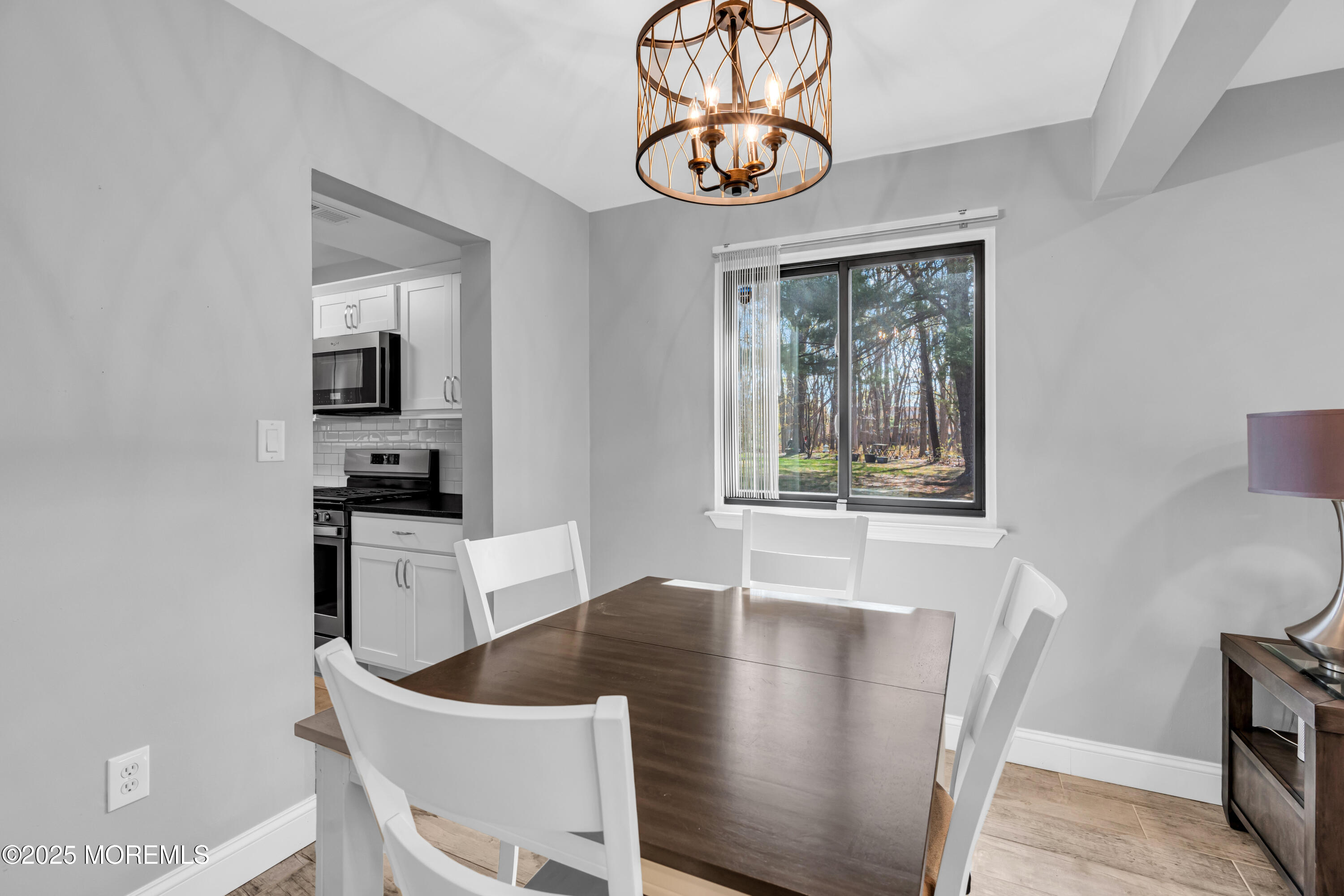 13 Owl Road, Unit 1000 Howell, NJ 07731 - Photo 11 of 39 a view of a dining room with furniture window and wooden floor