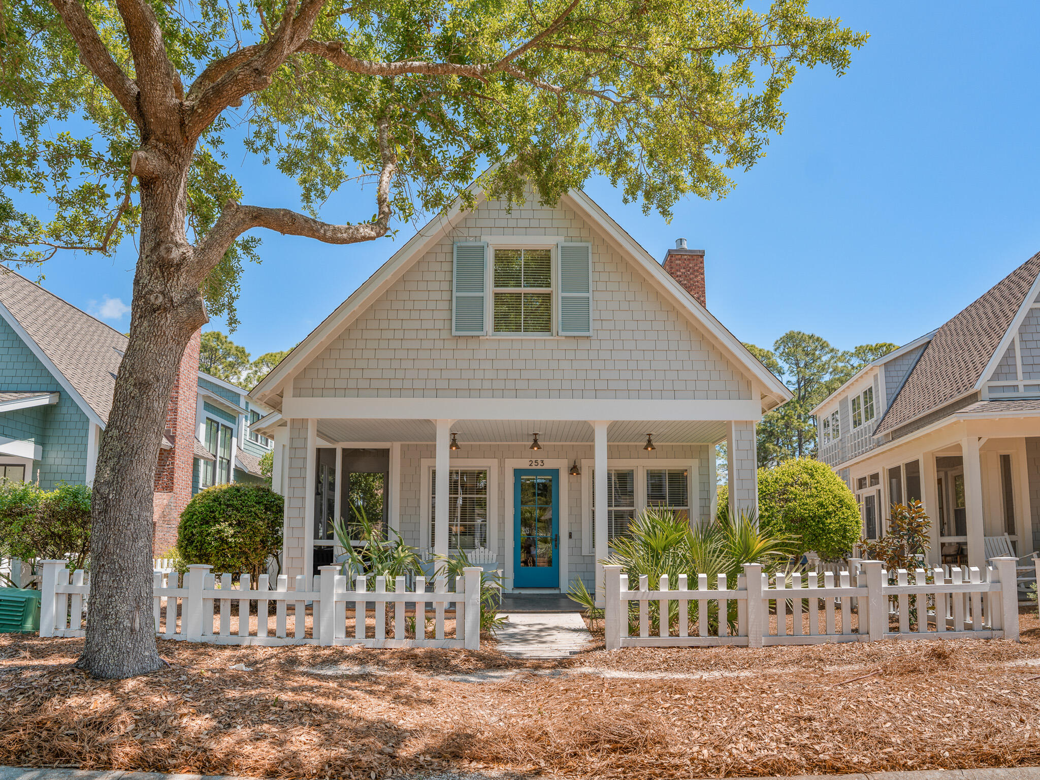 a front view of a house with a garden
