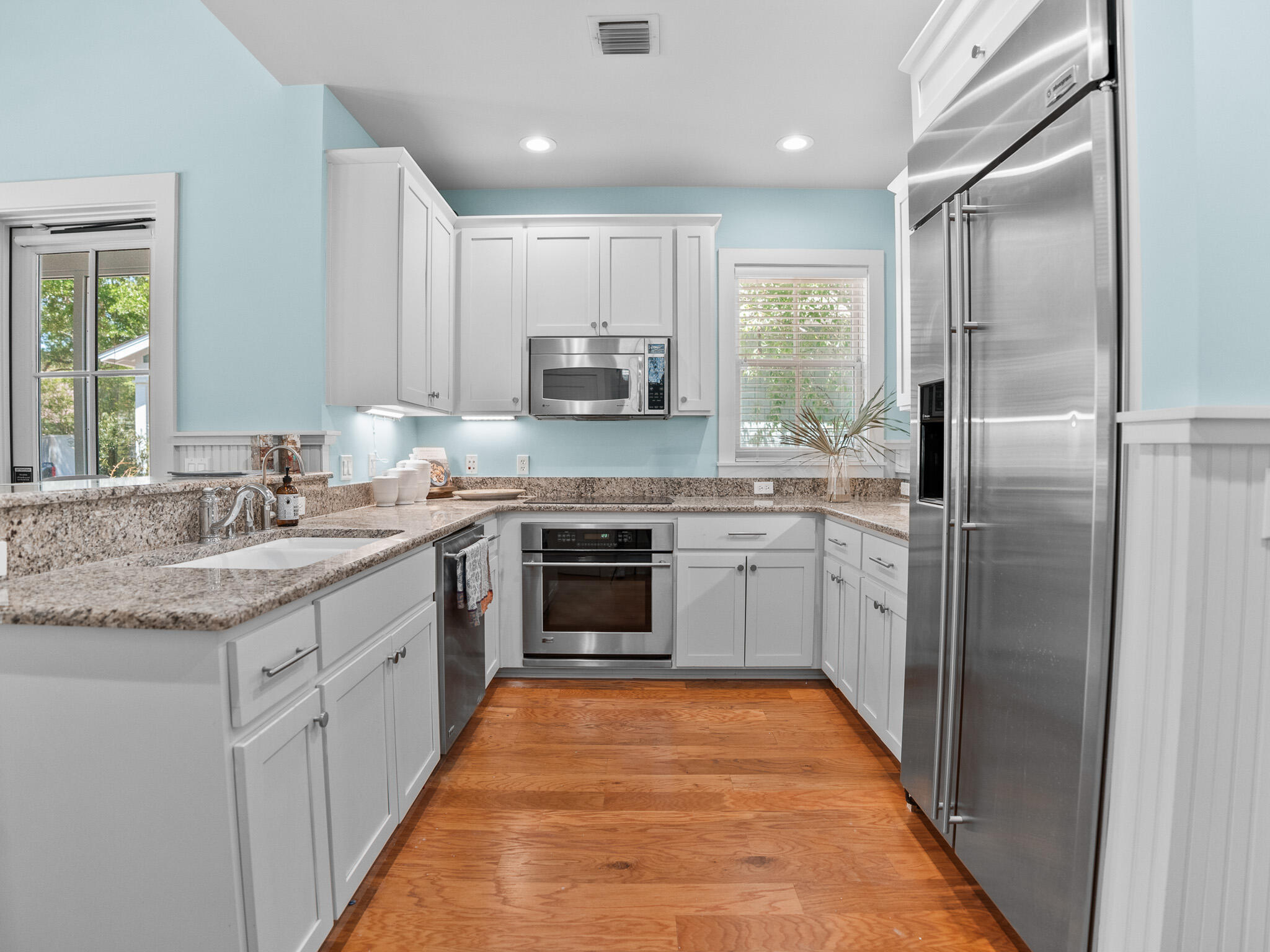 253 Salt Lane Watersound, FL 32461 - Photo 13 of 56 a kitchen with stainless steel appliances granite countertop a stove a sink and a refrigerator