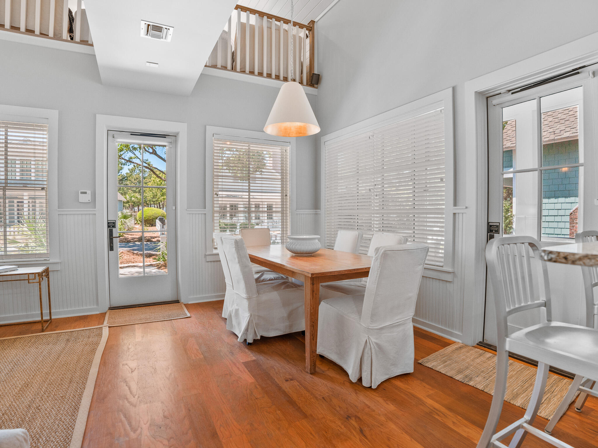 253 Salt Lane Watersound, FL 32461 - Photo 6 of 56 a dining room with furniture wooden floor and a rug