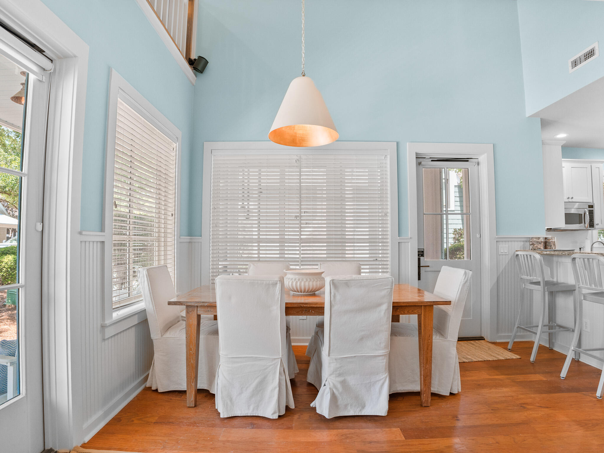 253 Salt Lane Watersound, FL 32461 - Photo 7 of 56 a dining room with wooden floor and a chandelier