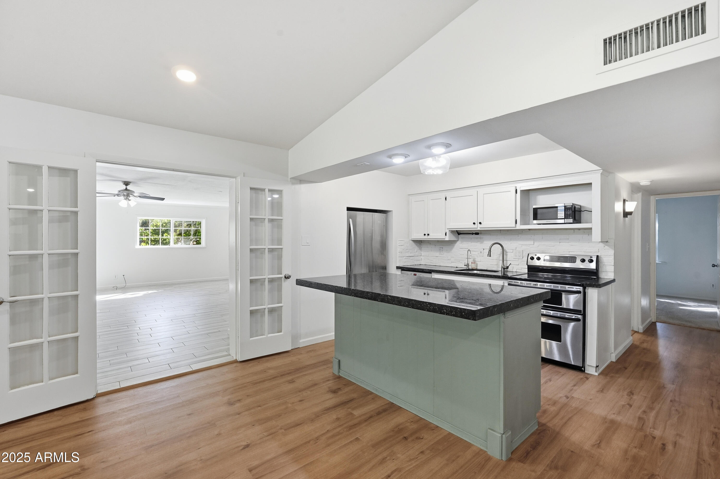21047 South 156th Street Gilbert, AZ 85298 - Photo 15 of 40 a kitchen with stainless steel appliances granite countertop a sink stove and refrigerator