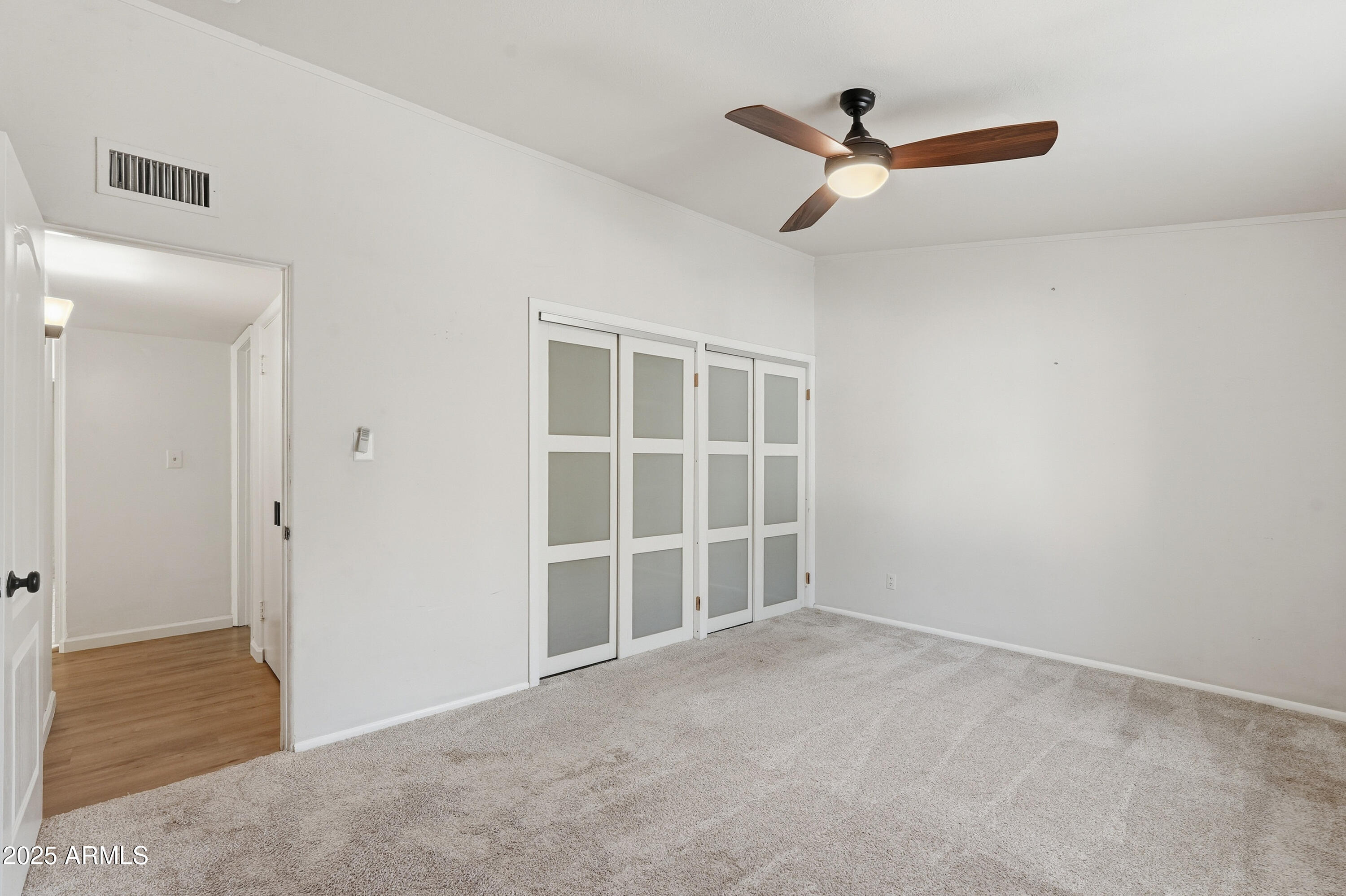 21047 South 156th Street Gilbert, AZ 85298 - Photo 22 of 40 a view of a livingroom with a ceiling fan and wooden floor