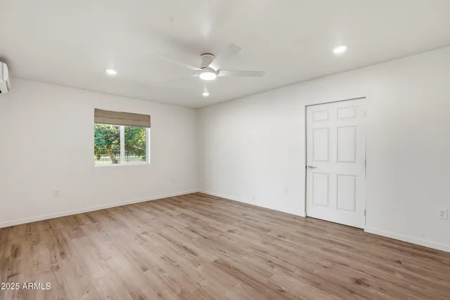 a view of empty room with wooden floor