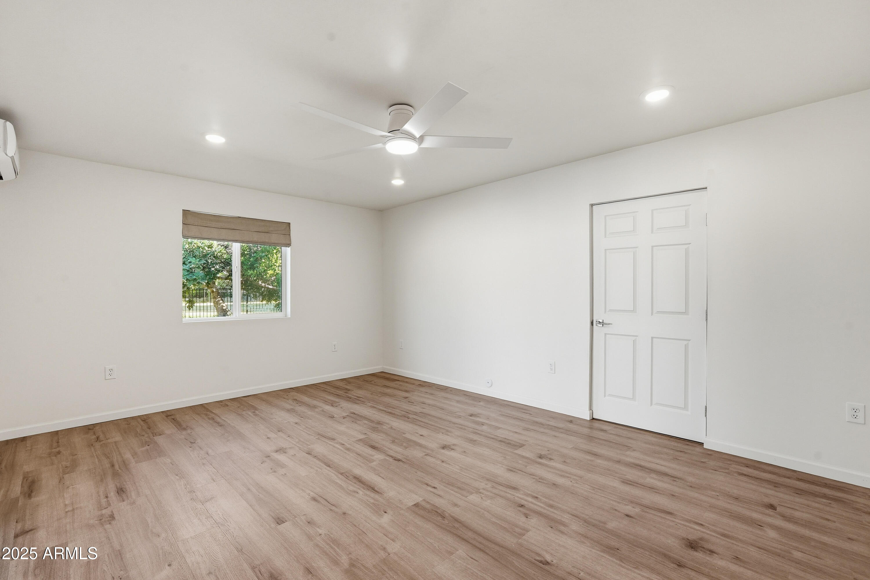 21047 South 156th Street Gilbert, AZ 85298 - Photo 28 of 40 an empty room with wooden floor chandelier fan and windows