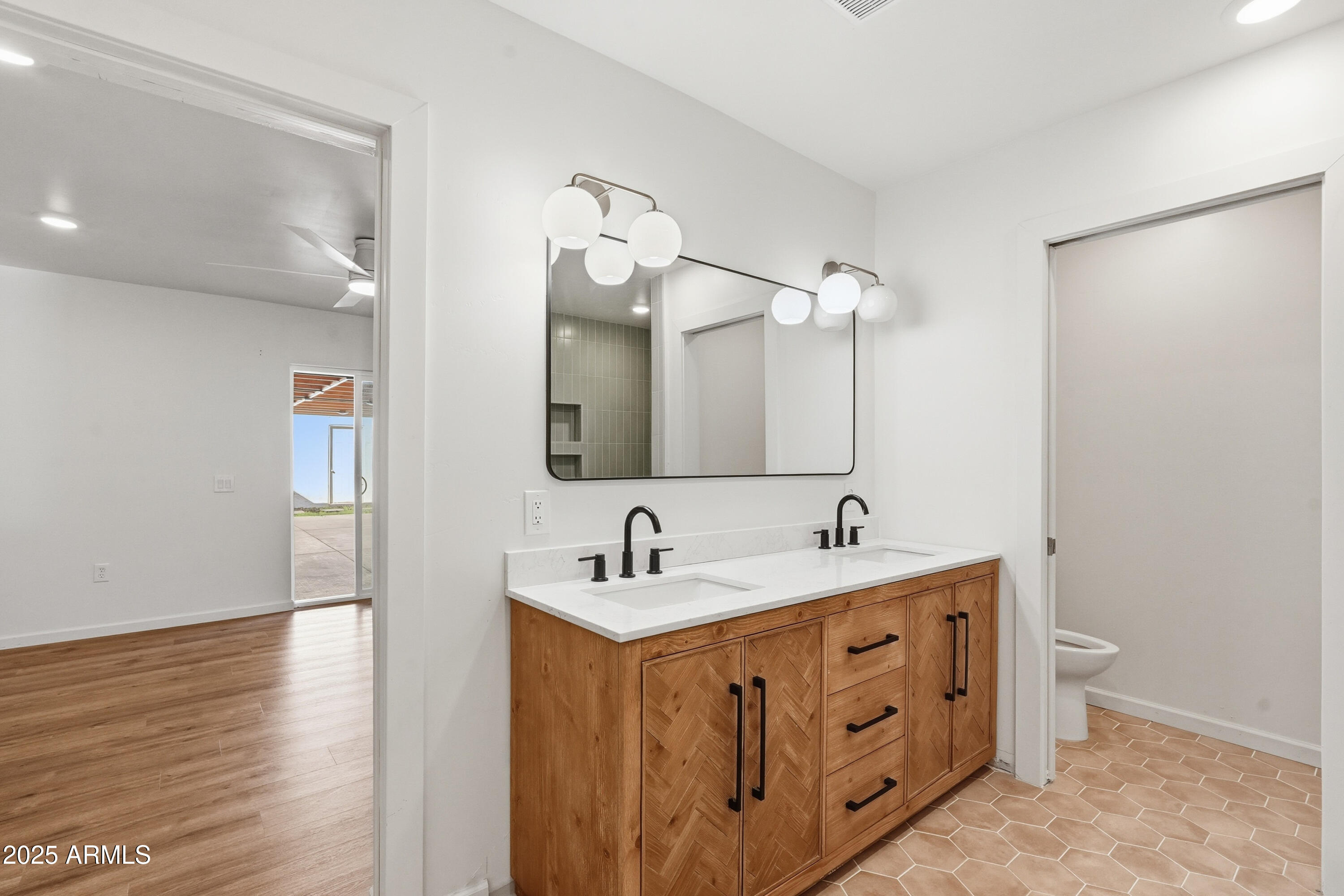 21047 South 156th Street Gilbert, AZ 85298 - Photo 34 of 40 a bathroom with a double vanity sink and a mirror
