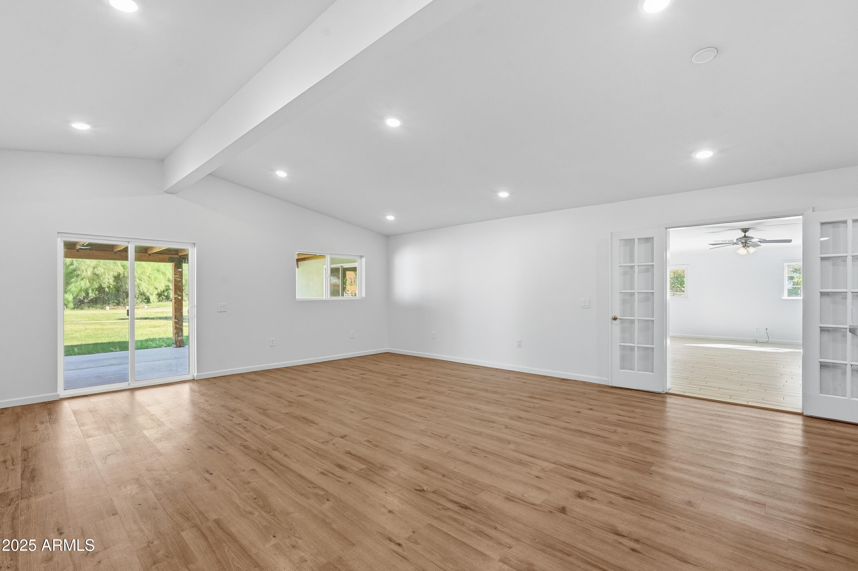 21047 South 156th Street Gilbert, AZ 85298 - Photo 6 of 40 an empty room with wooden floor and a window