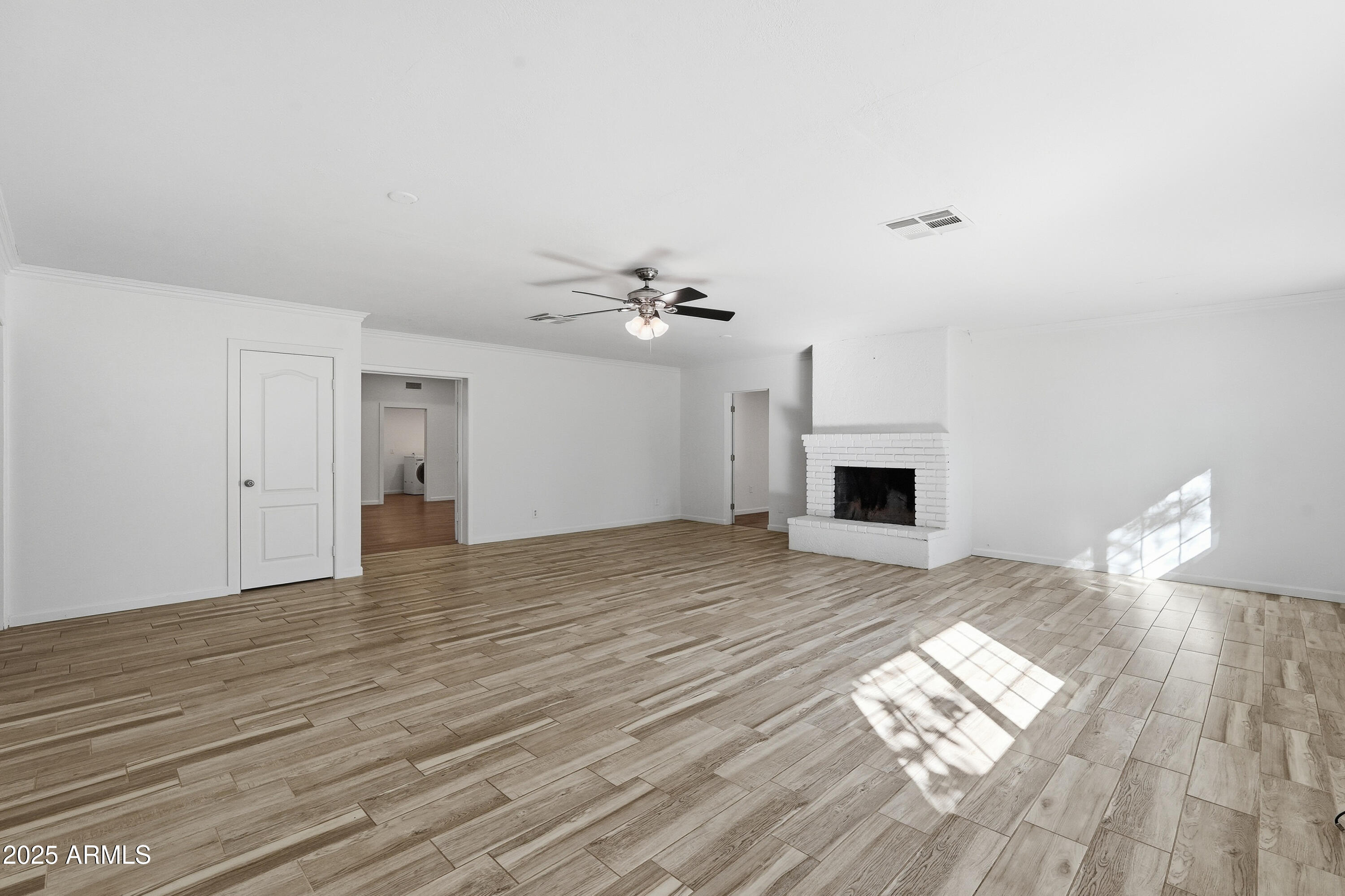 21047 South 156th Street Gilbert, AZ 85298 - Photo 10 of 40 a view of empty room with wooden floor and fireplace