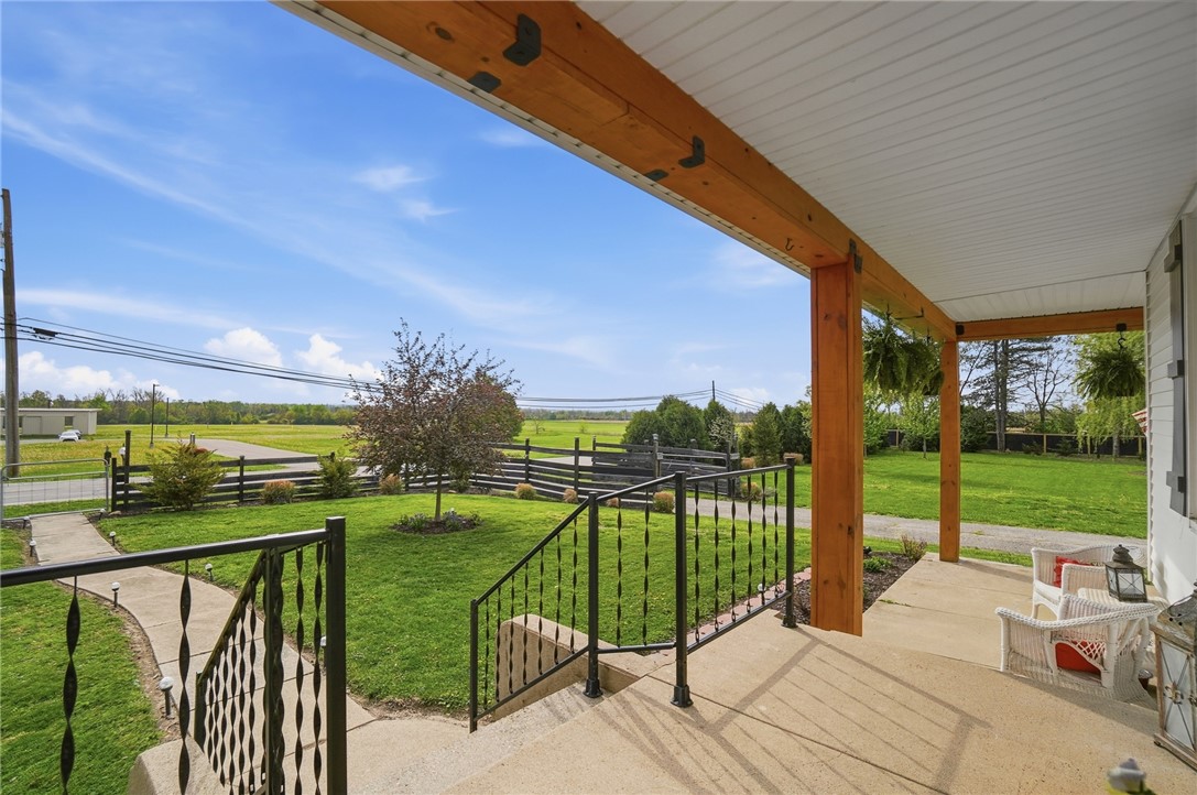 6155 North Union Road Clayton, OH 45315 - Photo 11 of 59 This inviting porch offers serene views of the surrounding landscape, perfect for relaxed outdoor moments.