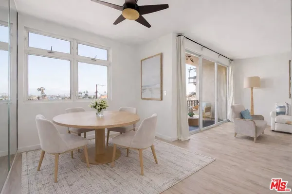 a view of a dining room with furniture window and wooden floor
