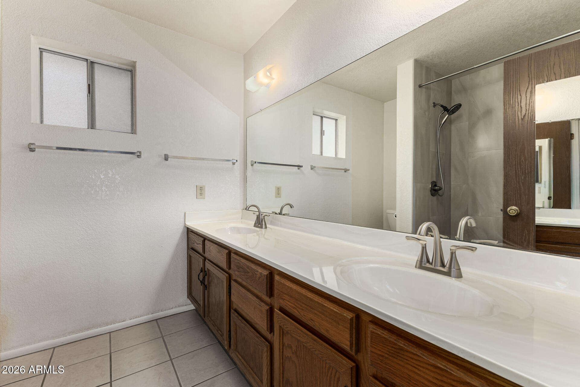 7926 West Shangri-la Road Peoria, AZ 85345 - Photo 16 of 32 a bathroom with a sink and a mirror