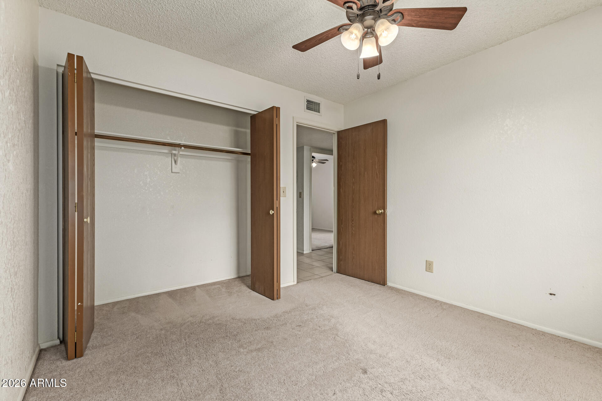 7926 West Shangri-la Road Peoria, AZ 85345 - Photo 20 of 32 a view of an empty room with a ceiling fan