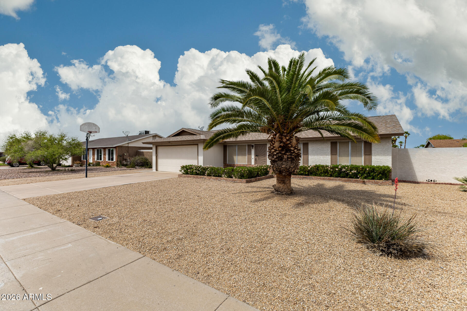 7926 West Shangri-la Road Peoria, AZ 85345 - Photo 2 of 32 a front view of a house with garden