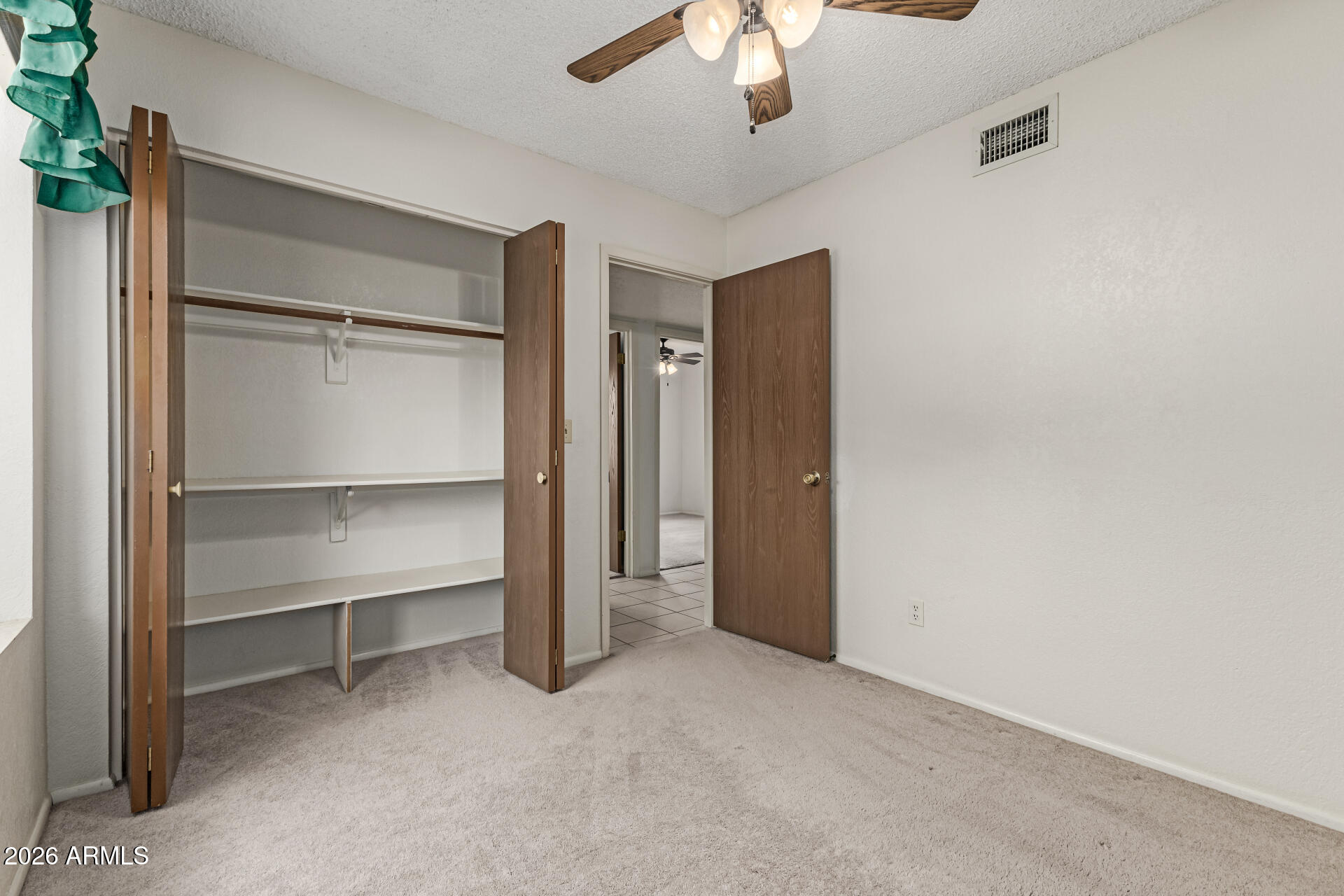 7926 West Shangri-la Road Peoria, AZ 85345 - Photo 24 of 32 a view of an empty room with a ceiling fan