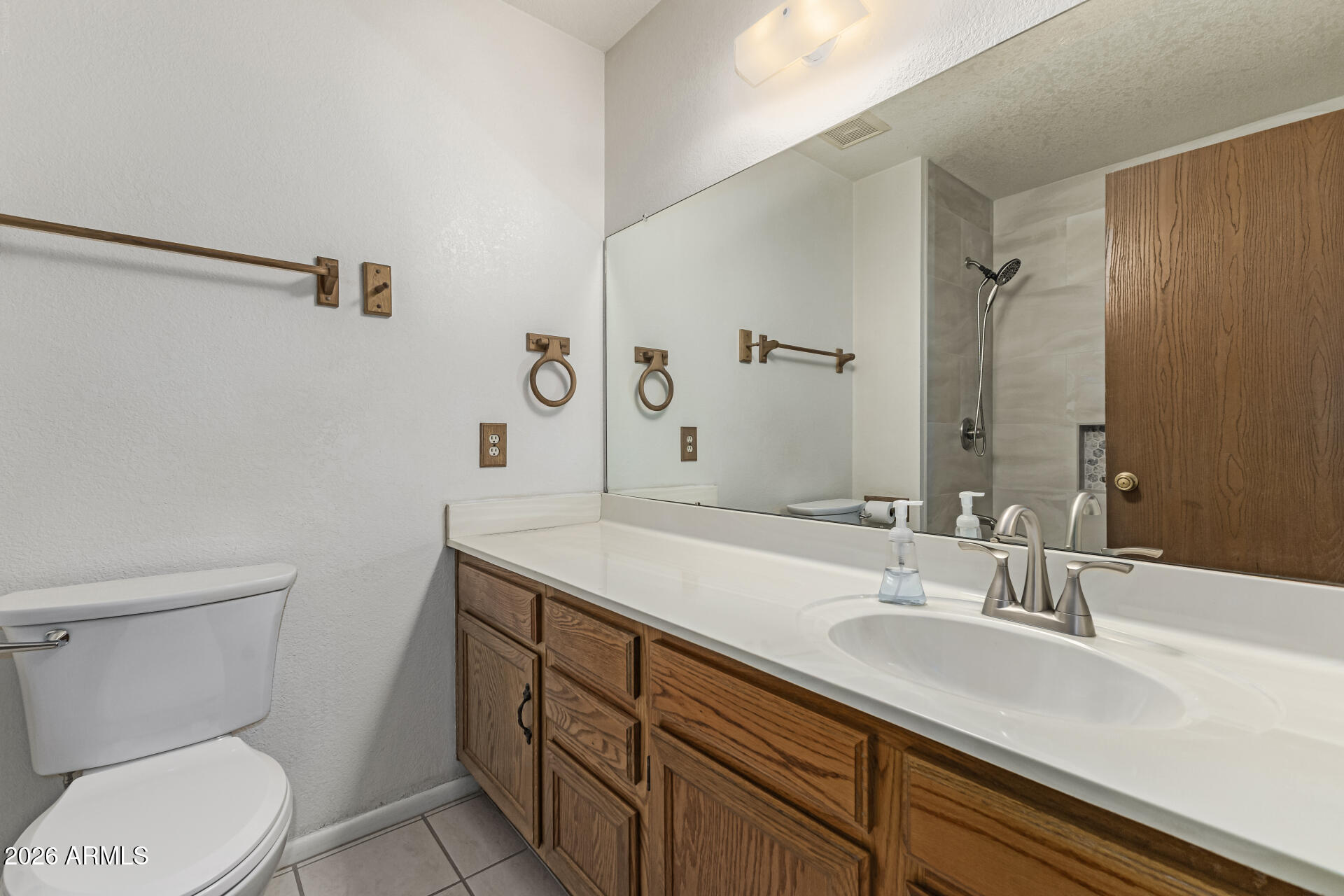 7926 West Shangri-la Road Peoria, AZ 85345 - Photo 25 of 32 a bathroom with a sink toilet vanity and shower