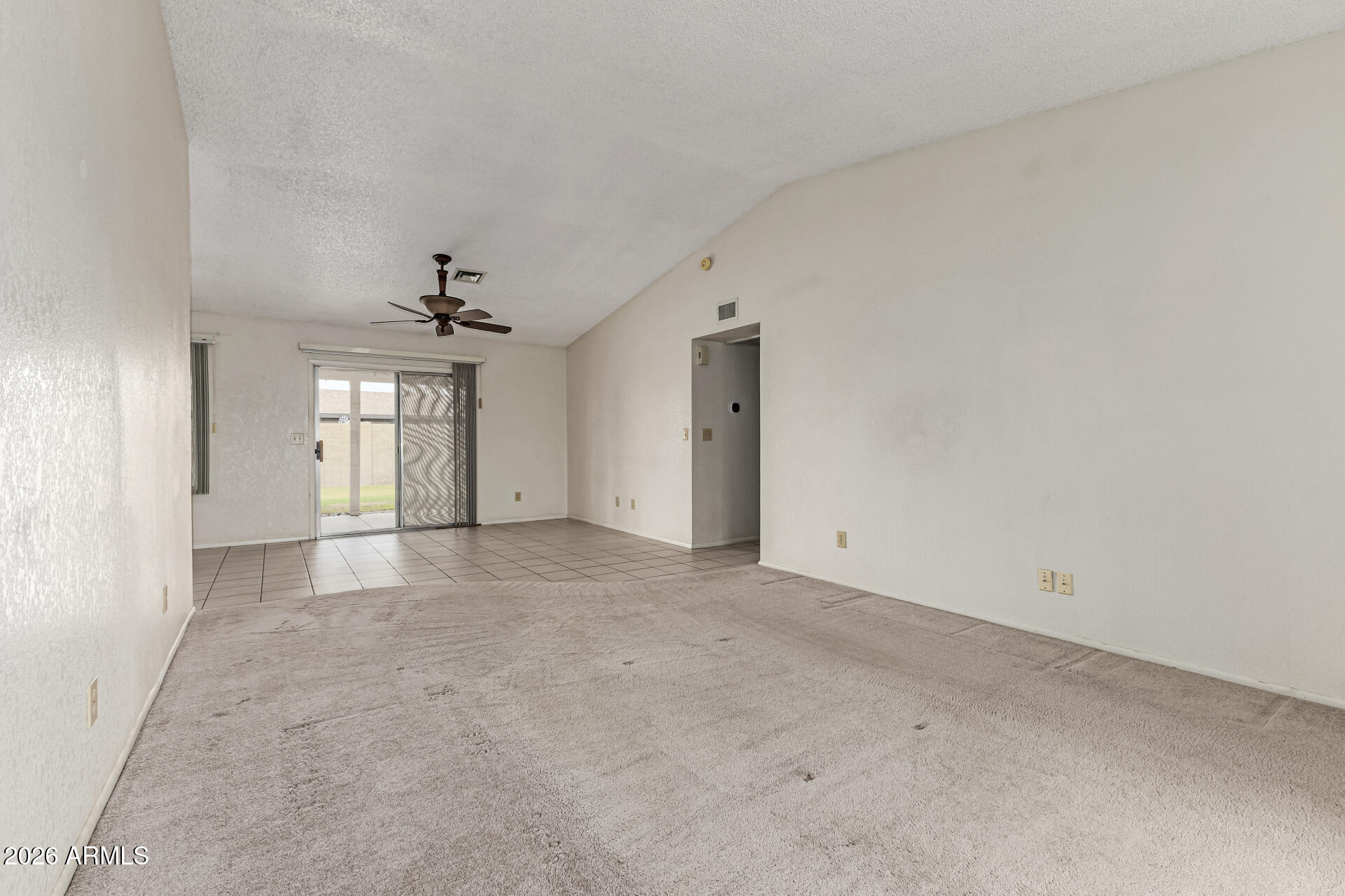 7926 West Shangri-la Road Peoria, AZ 85345 - Photo 5 of 32 an empty room with chandelier and windows