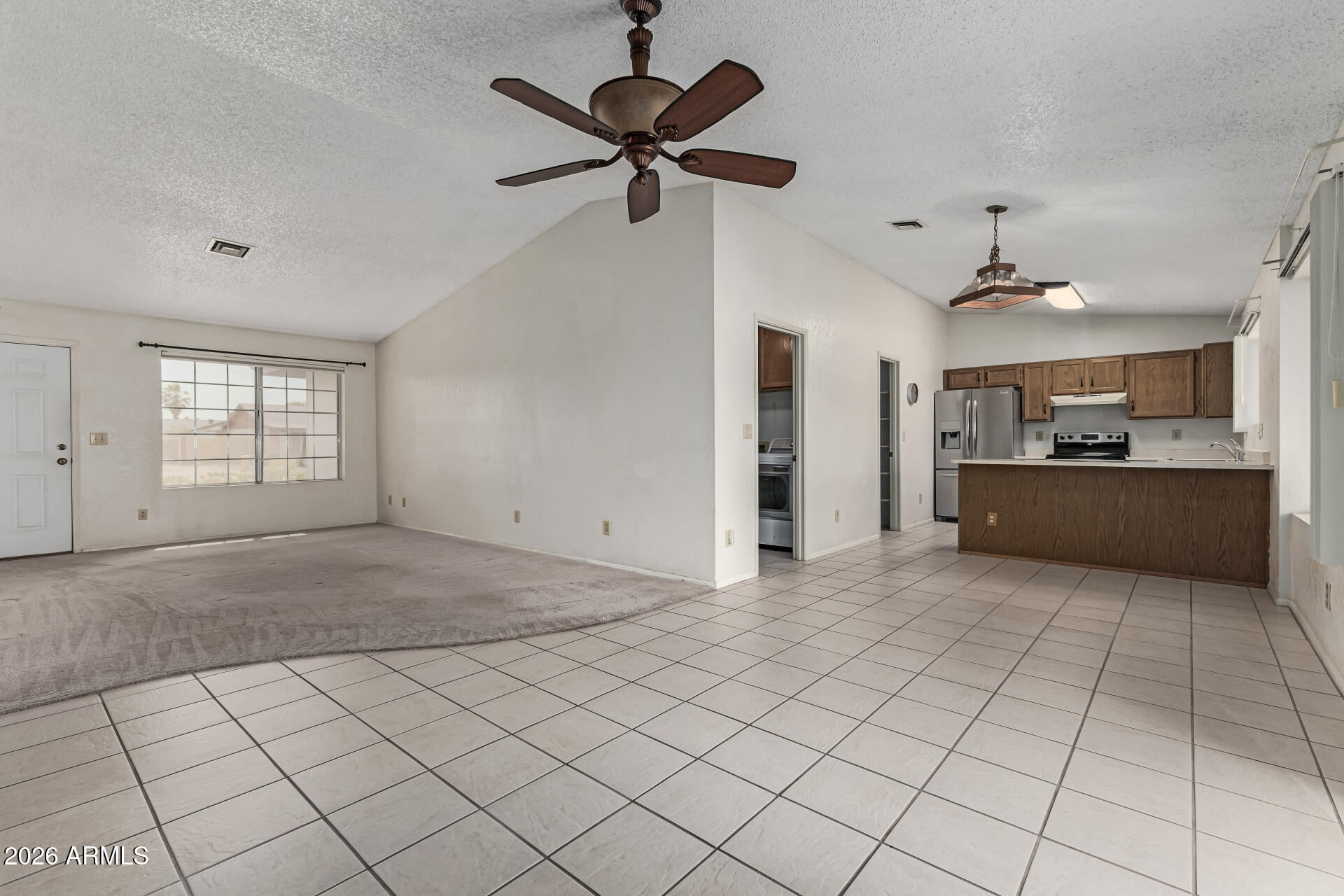 7926 West Shangri-la Road Peoria, AZ 85345 - Photo 7 of 32 a view of a livingroom with a ceiling fan and window
