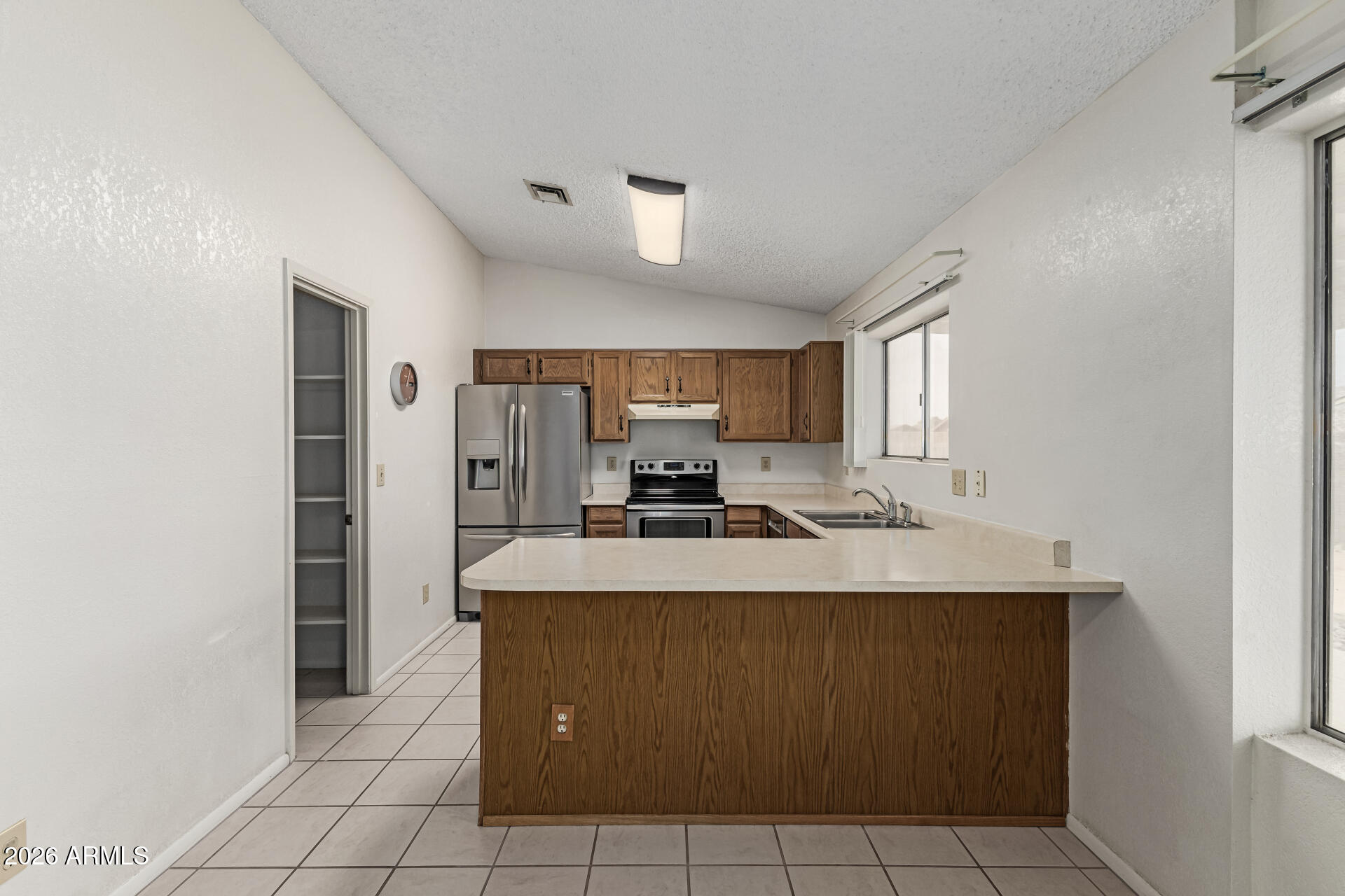 7926 West Shangri-la Road Peoria, AZ 85345 - Photo 8 of 32 a view of living room with stainless steel appliances granite countertop furniture and a view of bedroom