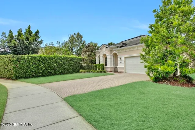 a front view of a house with a garden