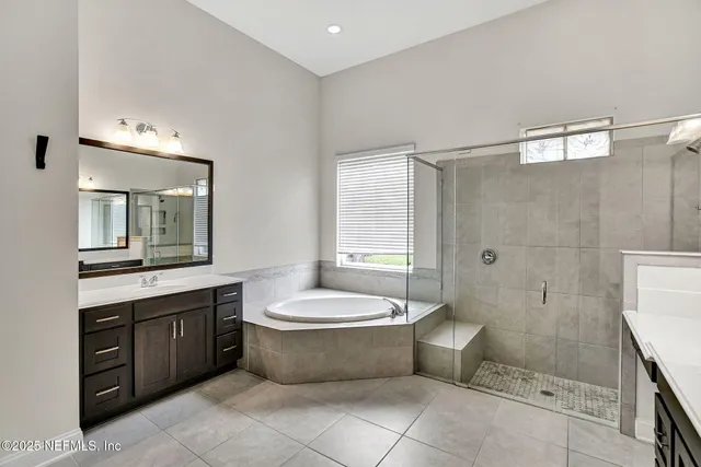a bathroom with a double vanity sink toilet and shower