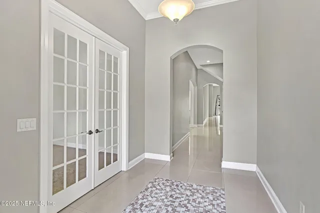 a view of a hallway with wooden floor and a bathroom