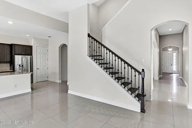 a view of hallway with stairs and wooden floor