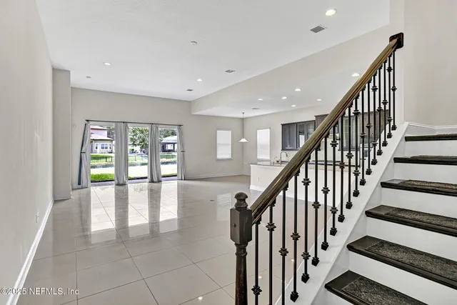 a view of entryway and hall with wooden floor