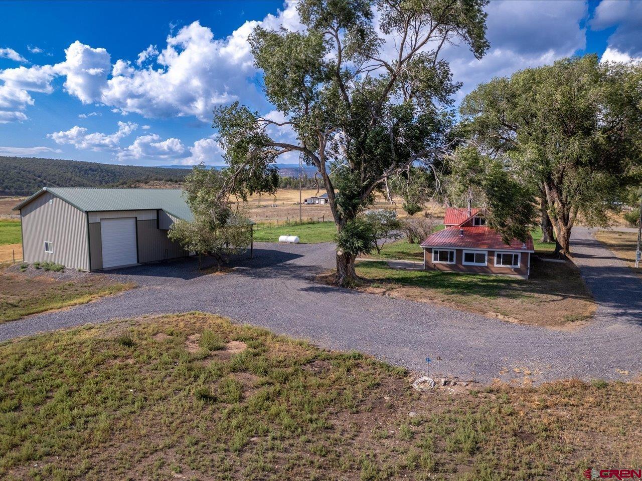a backyard of a house with table and chairs