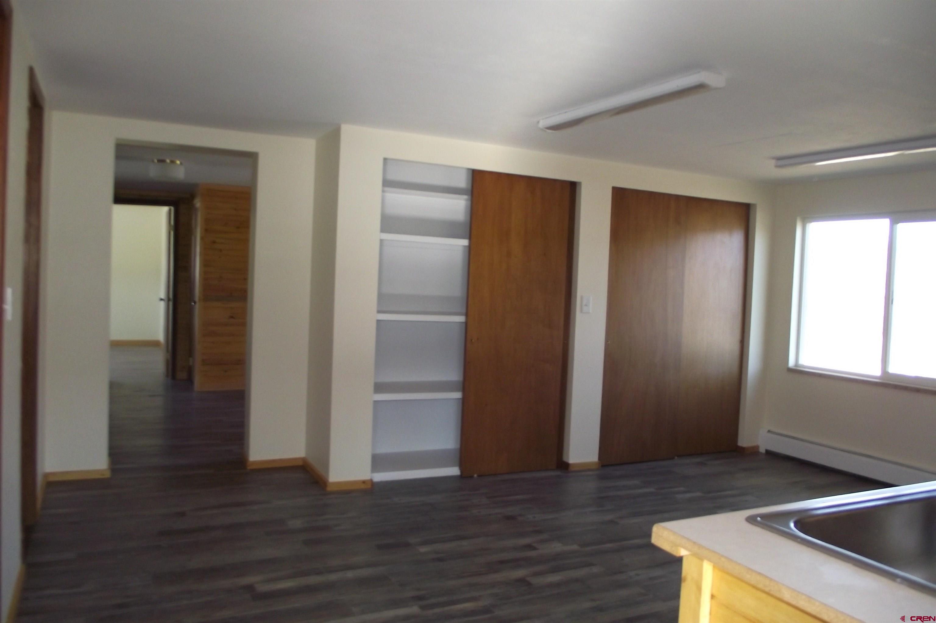 27434 Cedar Mesa Road Cedaredge, CO 81413 - Photo 13 of 36 an empty room with wooden floor & closet area