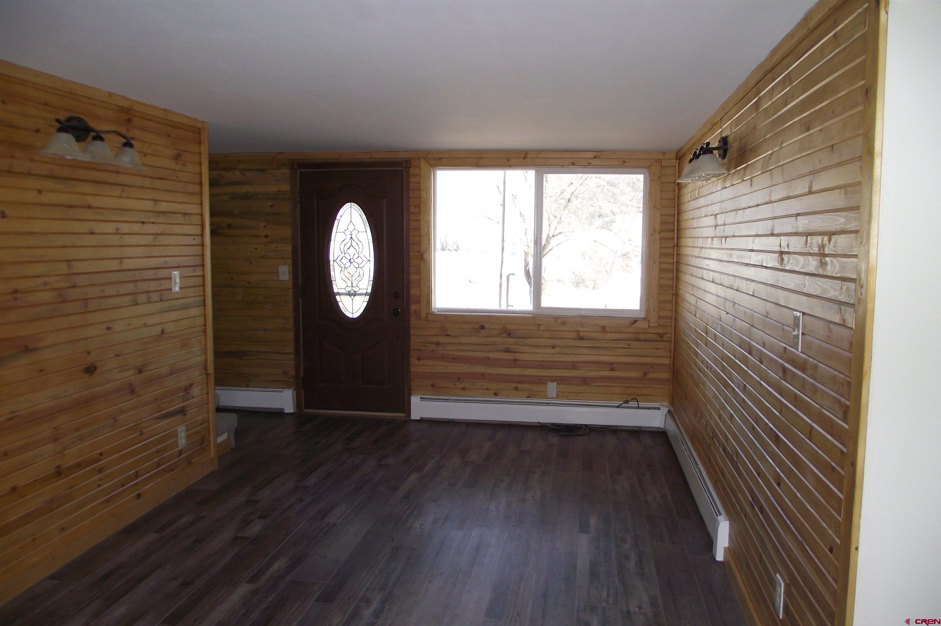 27434 Cedar Mesa Road Cedaredge, CO 81413 - Photo 18 of 36 a view of a small space with wooden floor and a window