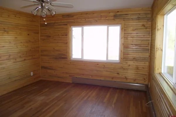 an empty room with wooden floor