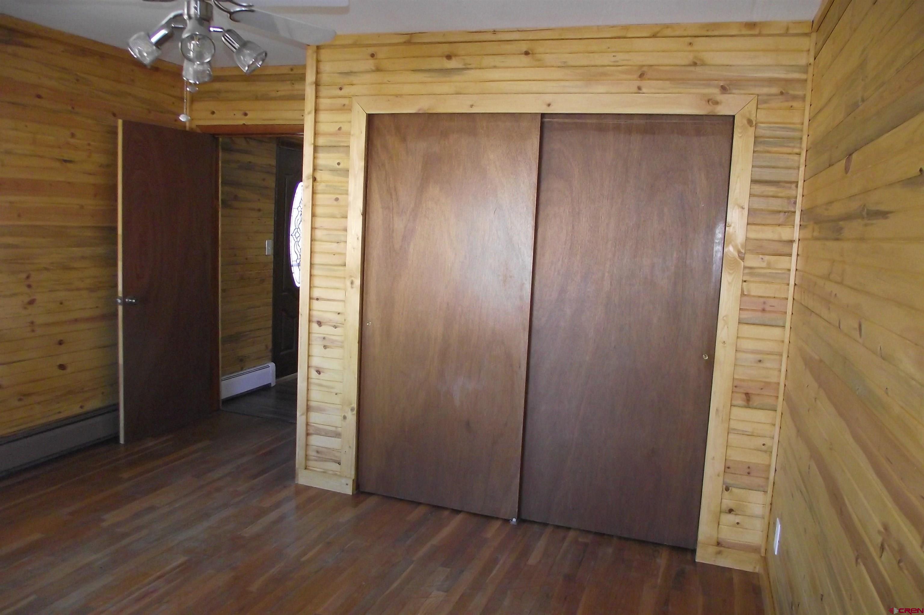 27434 Cedar Mesa Road Cedaredge, CO 81413 - Photo 26 of 36 an empty room with wooden floor