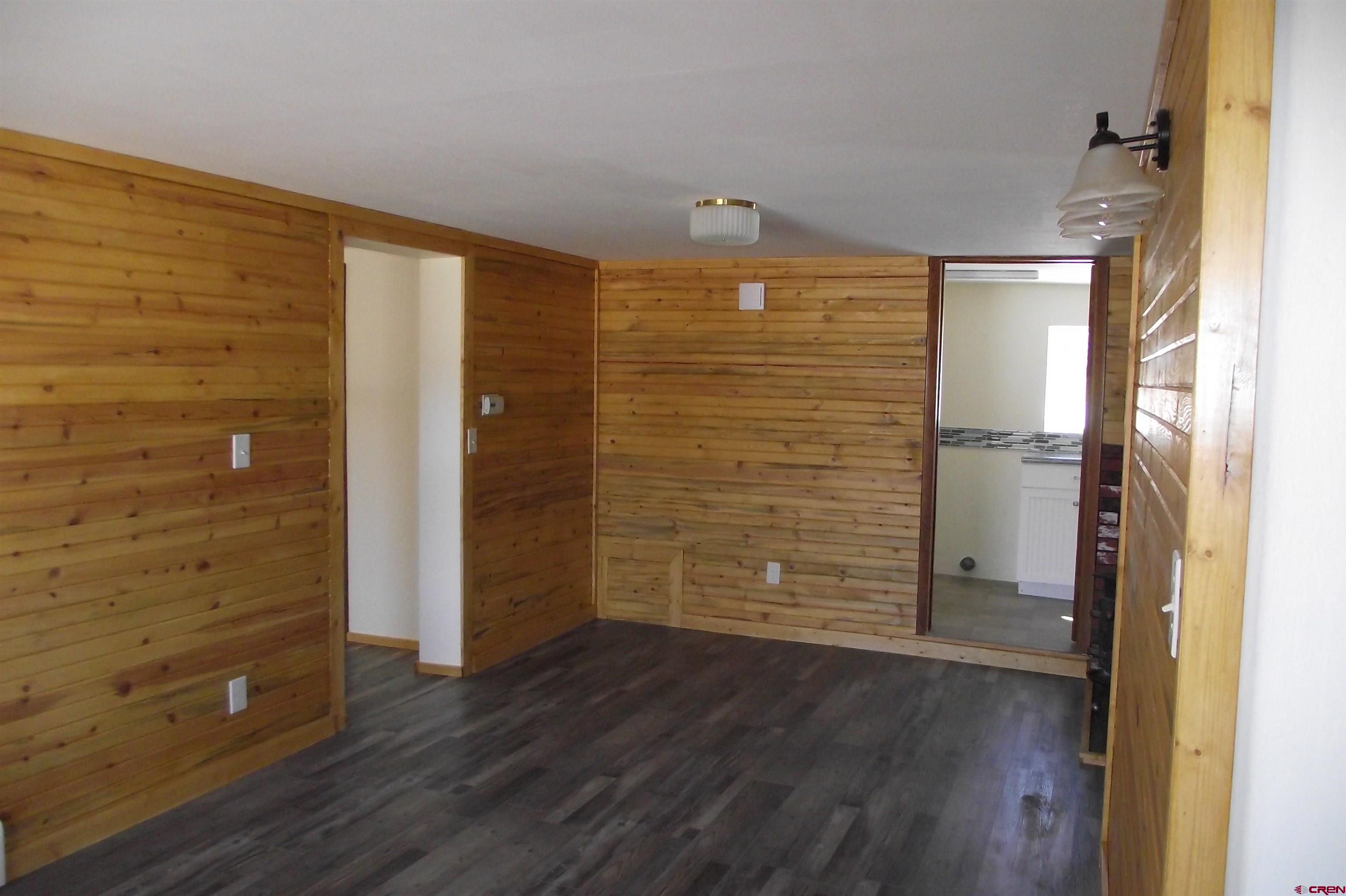 27434 Cedar Mesa Road Cedaredge, CO 81413 - Photo 31 of 36 a view of empty room with wooden floor
