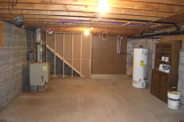 a kitchen with a refrigerator sink and cabinets