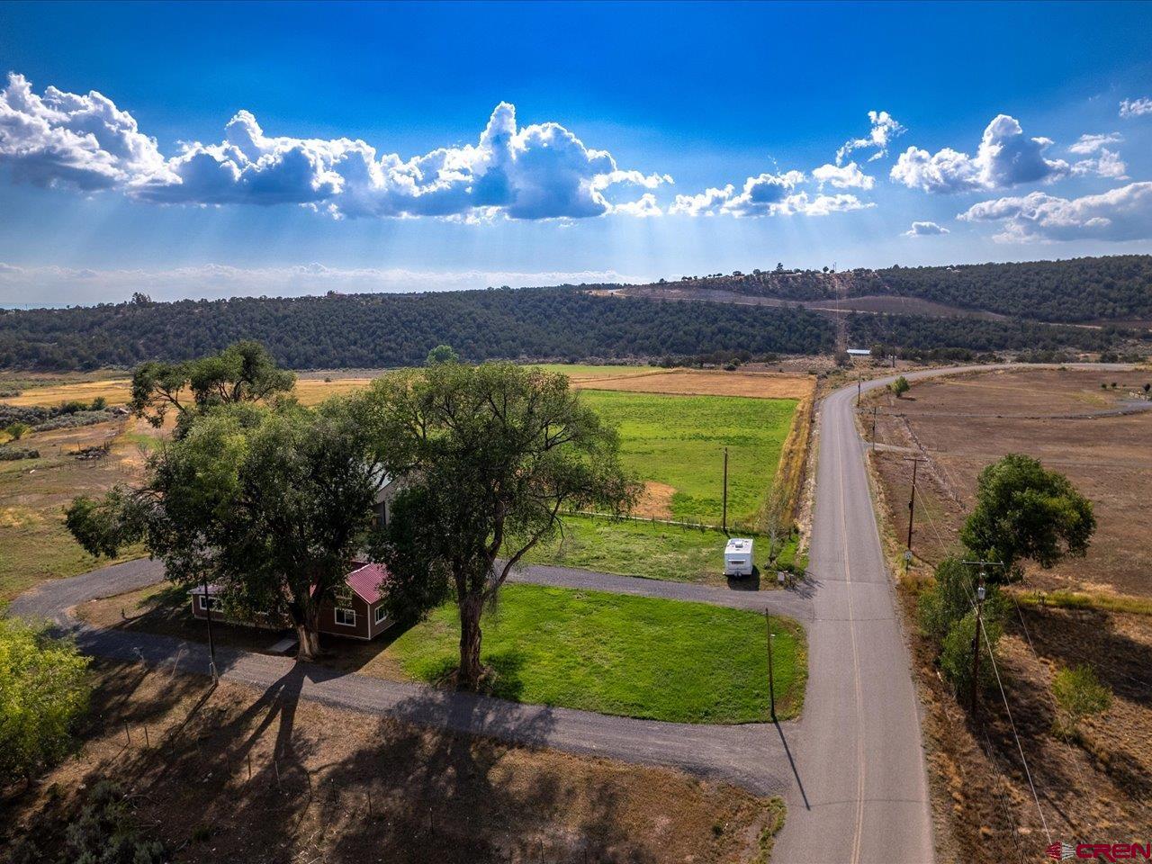 27434 Cedar Mesa Road Cedaredge, CO 81413 - Photo 4 of 36 a view of a lake with a outdoor space