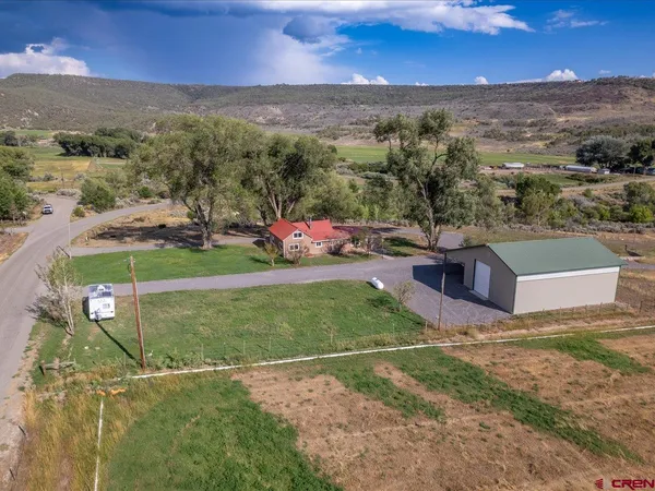 an aerial view of a house with a yard