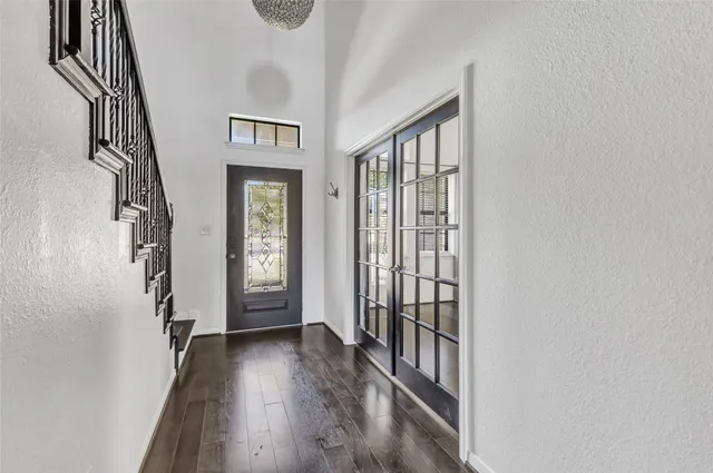 a view of a hallway with wooden floor and stairs