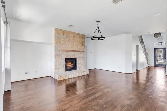 a view of a room with wooden floor and fireplace