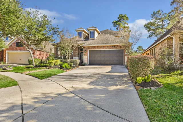 a front view of a house with a yard and a garage