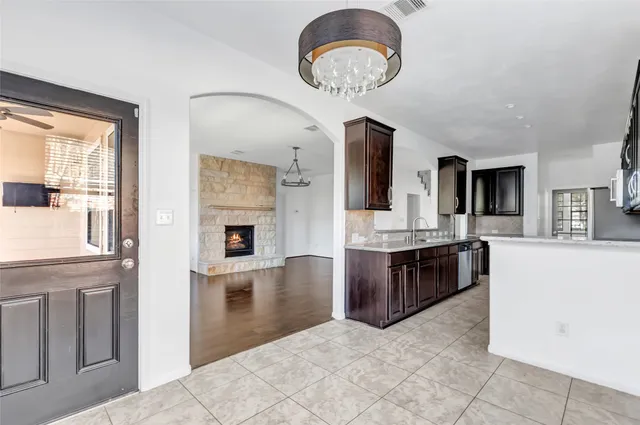a kitchen with kitchen island granite countertop stainless steel appliances stove a sink and a refrigerator