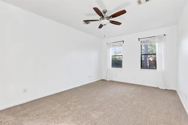 an empty room with a empty space and windows