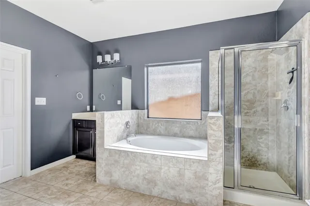 a bathroom with a bathtub and a shower