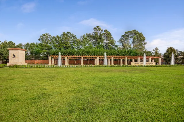 a front view of a house with a big yard