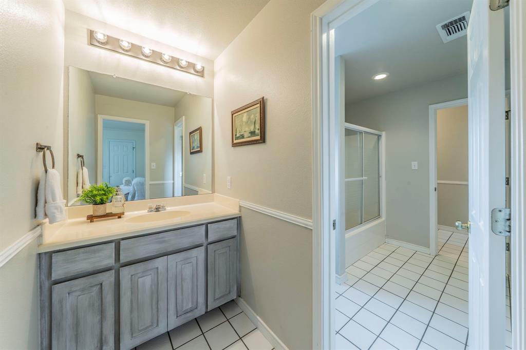 1992 Bledsoe Road Gunter, TX 75058 - Photo 19 of 40 a view of bathroom with double vanity sink and mirror
