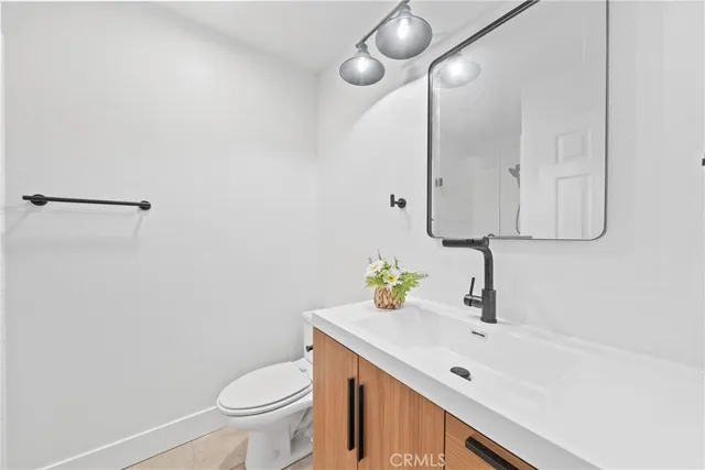 a bedroom with a bed and a mirror