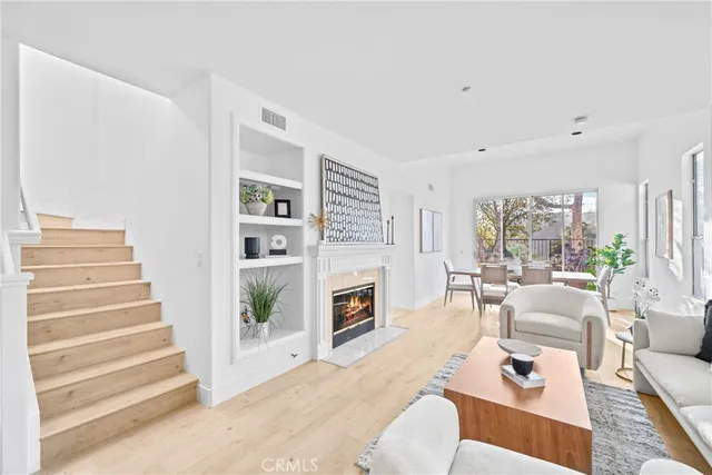 a living room with furniture fireplace and flat screen tv