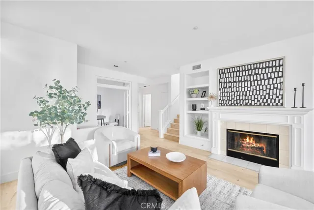 a living room with furniture a fireplace and a table