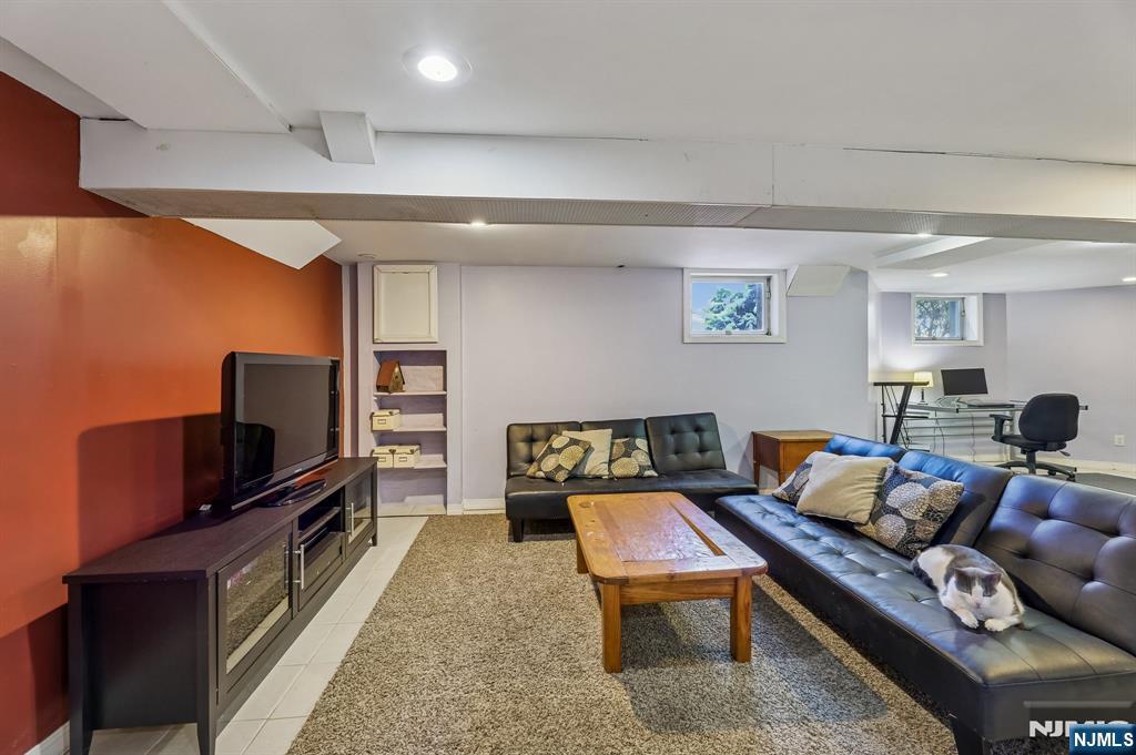 133 Hudson Avenue Ridgefield Park, NJ 07660 - Photo 12 of 14 a living room with furniture and a flat screen tv